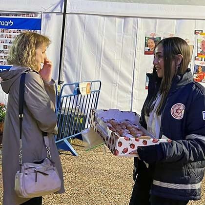 MDA celebrates Chanukah with families of hostages.